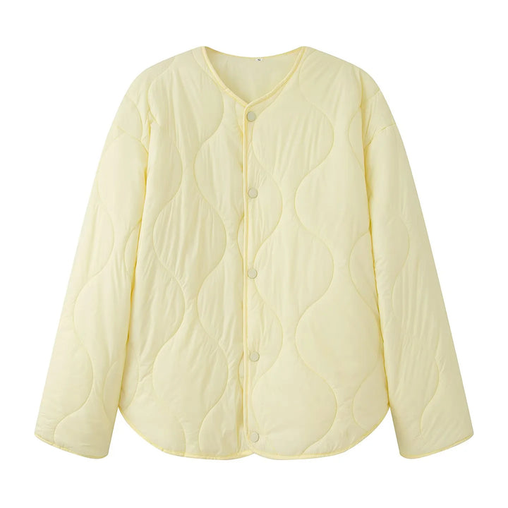 Women's quilted transition jacket with round neckline, snap button closure, and curved hem Mune Fashion