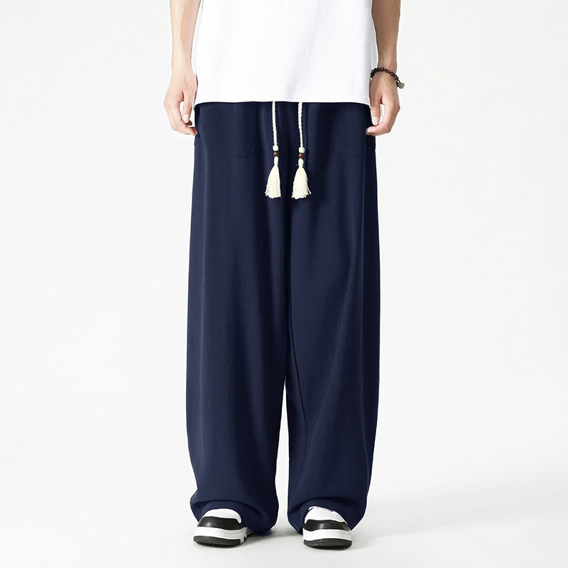 Men's loose-fitting lounge pants with tassel cord, elastic waistband, and patch pockets Mune Fashion