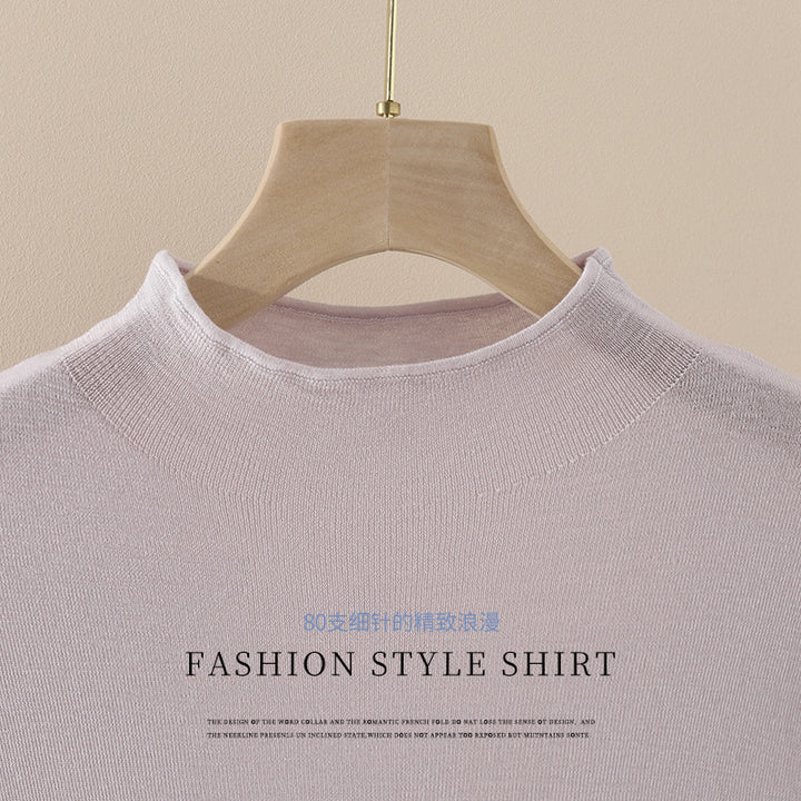 Women's fine fine-knit top with a short high collar, three-quarter sleeves, and a flattering drape.