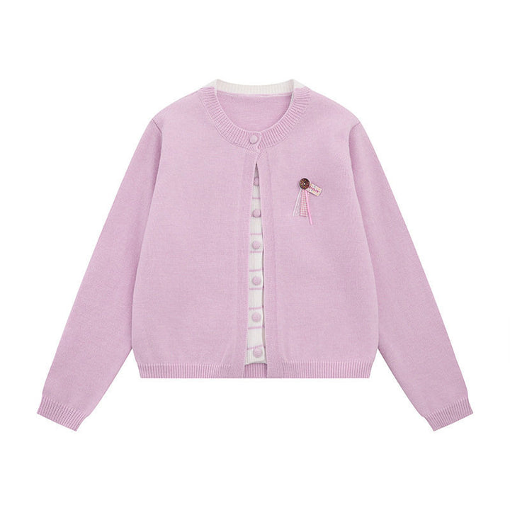 Ladies fine knit cardigan with round neckline, concealed button placket, and decorative brooch Mune Fashion