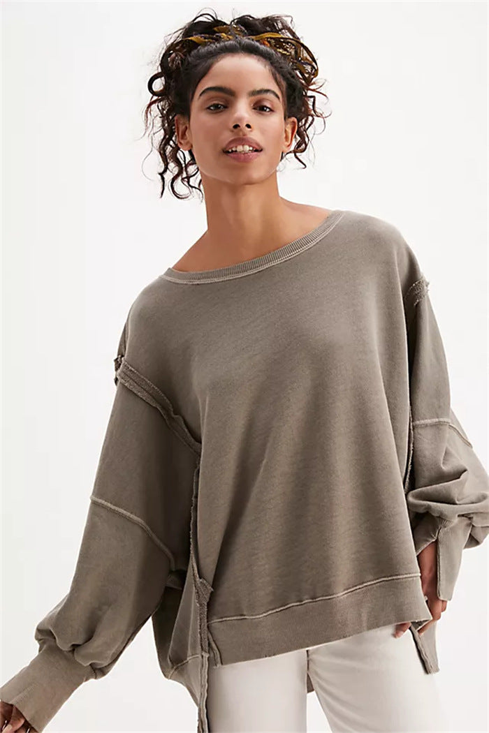 Women's oversized sweatshirt with balloon sleeves, open seam stitches, and side slits Mune Fashion