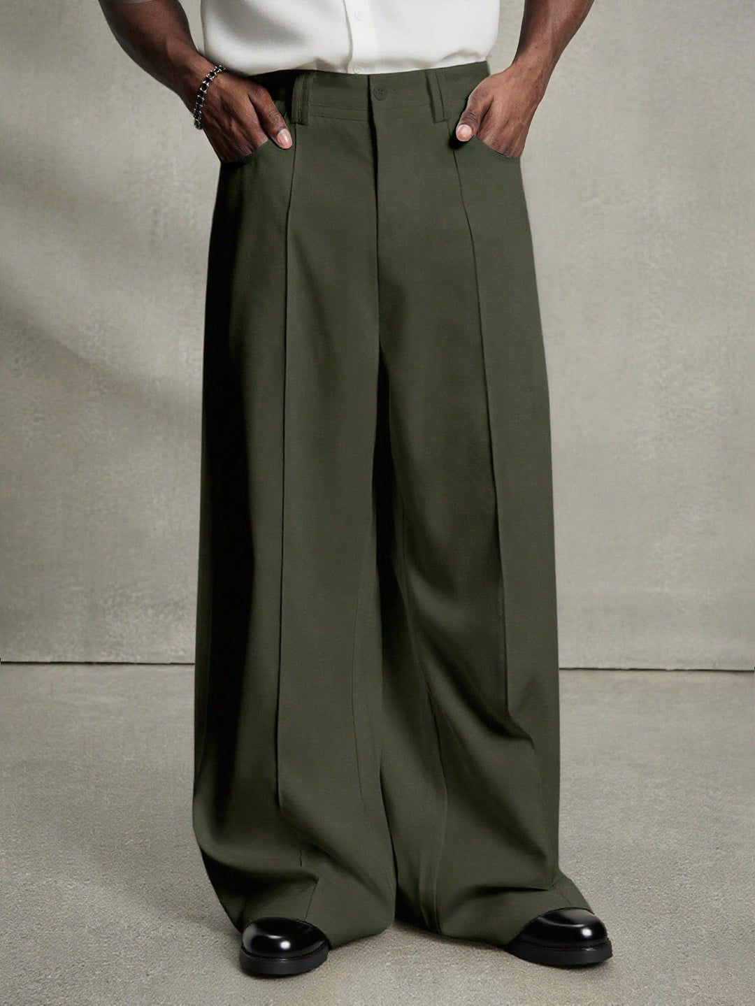 Men's wide pleated pants with high waistband, precise creases, and side inset pockets Mune Fashion