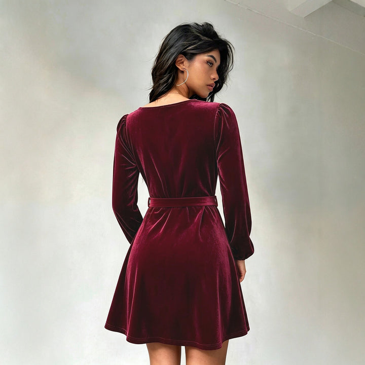 Women's elegant velvet mini dress with V-neck, button placket, balloon sleeves, and waist belt.