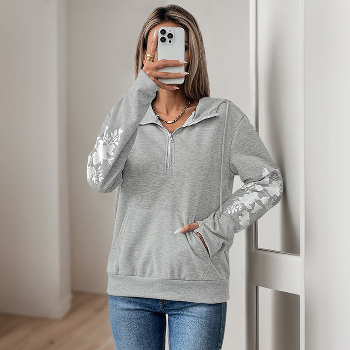 Women's hoodie with half zipper, kangaroo pocket & floral sleeve appliqués Mune Fashion