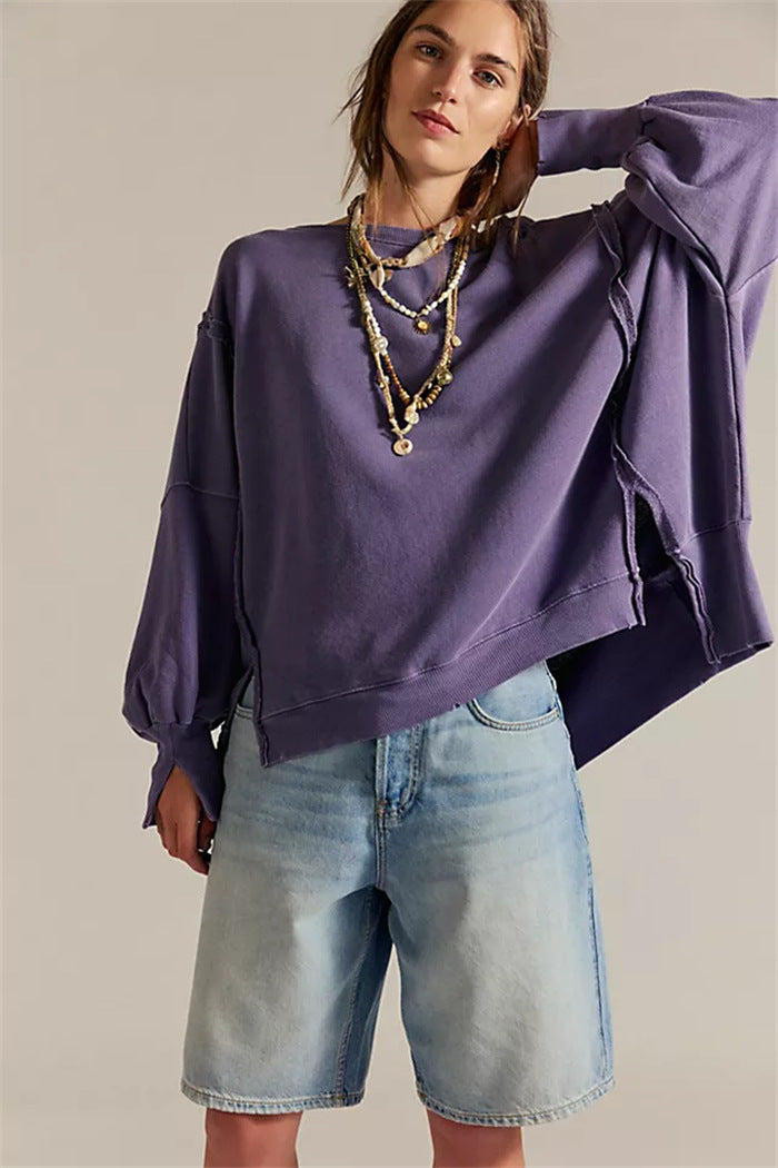 Women's oversized sweatshirt with balloon sleeves, open seam stitches, and side slits Mune Fashion
