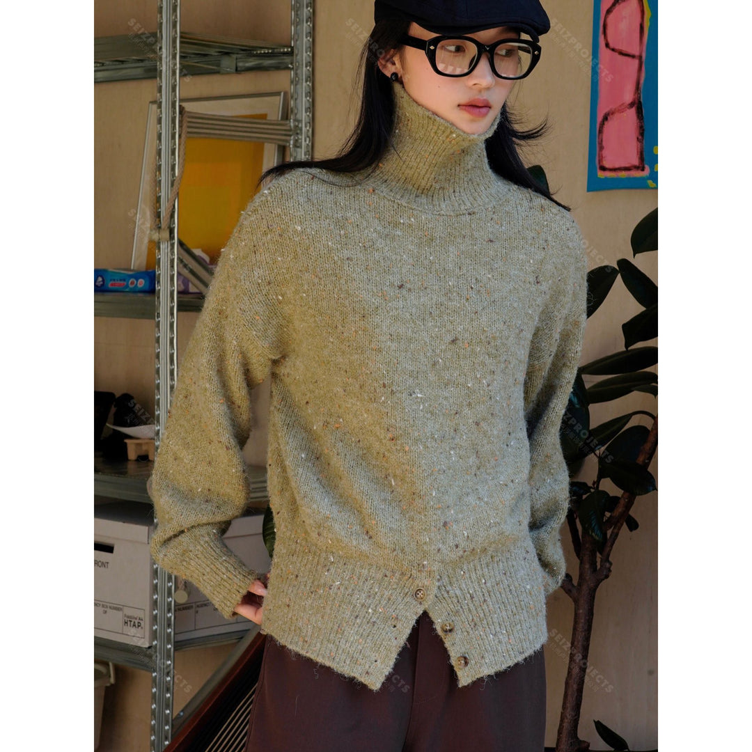 Women's chunky knit turtleneck sweater with button placket at the hem
