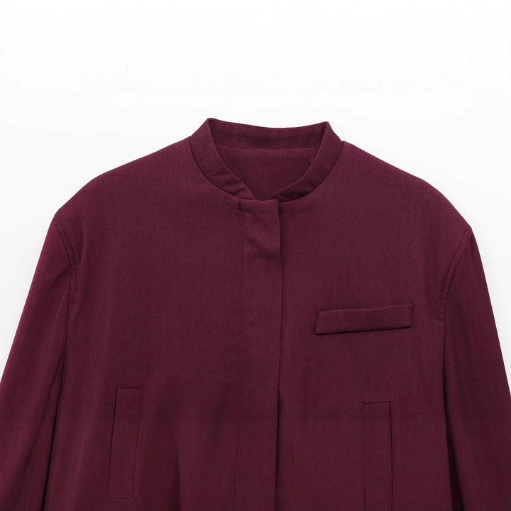 Ladies nan short stand collar blouson jacket with concealed front placket, fitted ribbed waistband details and decorative piped pockets Mune Fashion