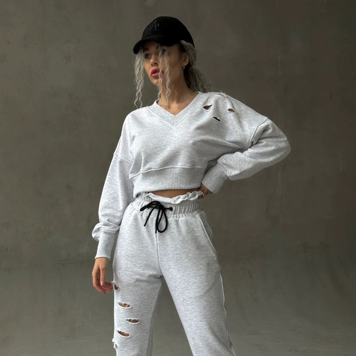 Ladies short-cut sweat set with V-neck, ruffled waistband high-waist joggers and distressed details Mune Fashion