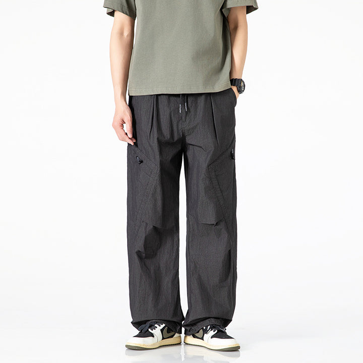 Men's loose-fitting nylon cargo pants with drawstring waistband and angled utility pockets Mune Fashion