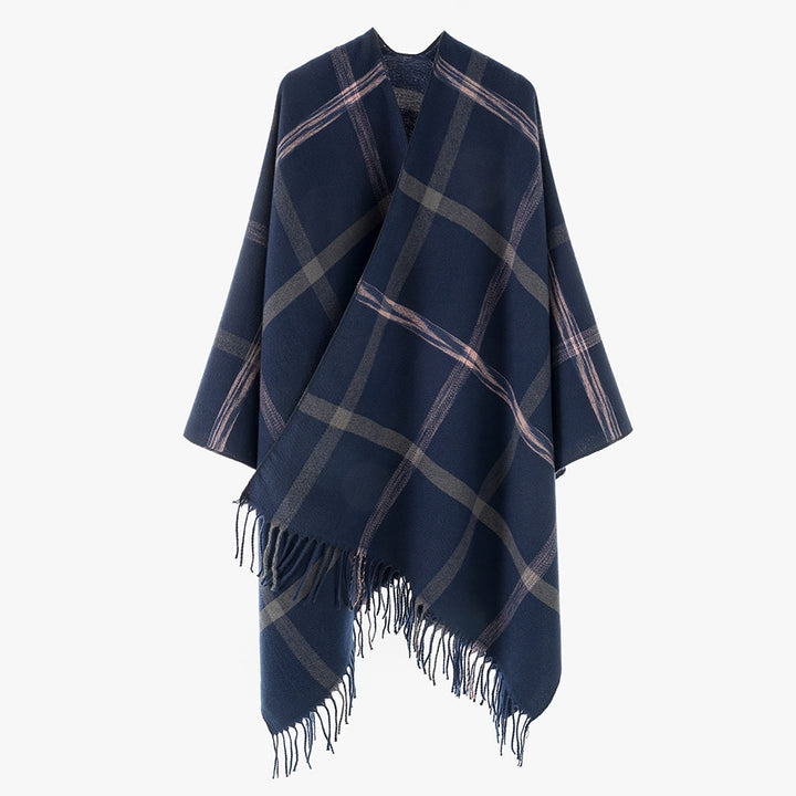 Women's large checkered wool look poncho in cape cut with loose drape and fringes.