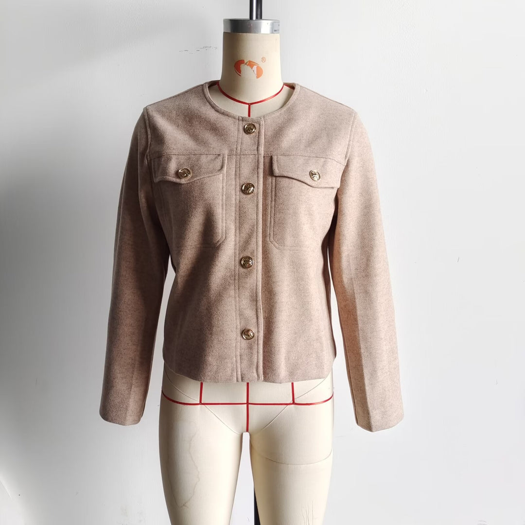 Women's structured short jacket with round neck, breast pockets, and decorative metal button strip Mune Fashion