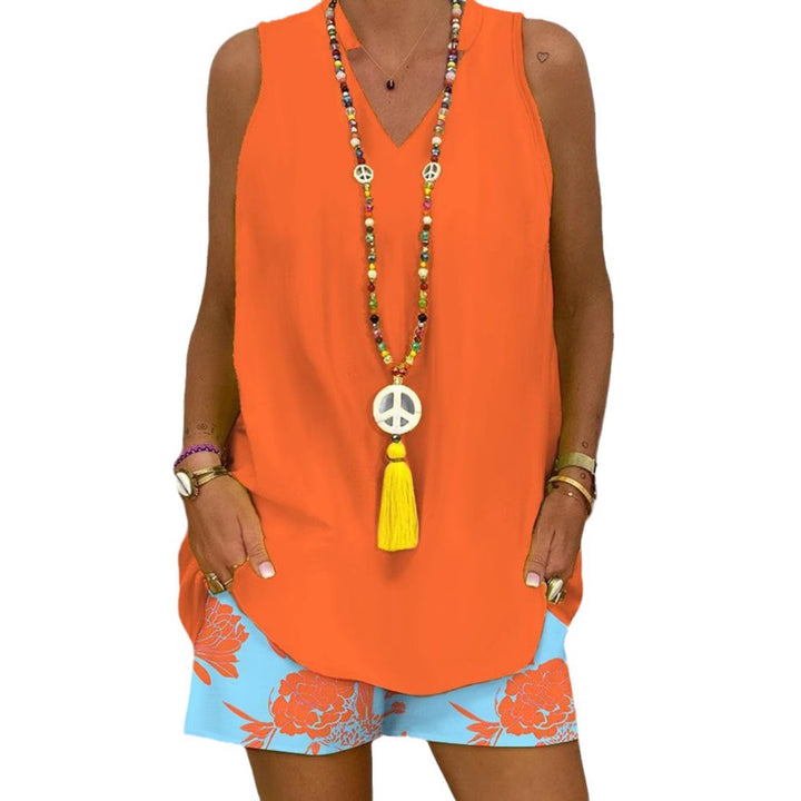 Women's sleeveless V-neck long top with curved hem and side insertion pockets Mune Fashion