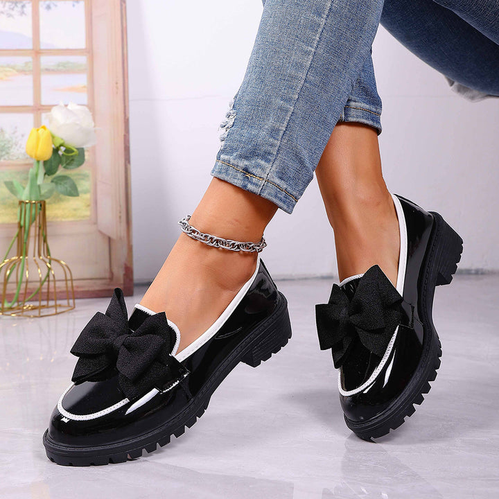 Women's patent leather platform loafers with patterned rubber sole and decorative bow Mune Fashion