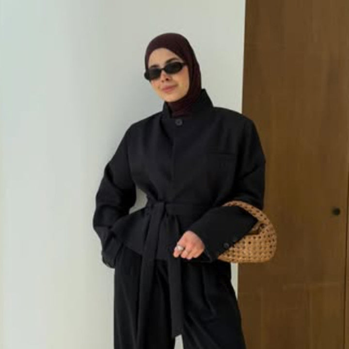 Women's tailored short blazer with standing collar, peplum, and tie belt Mune Fashion