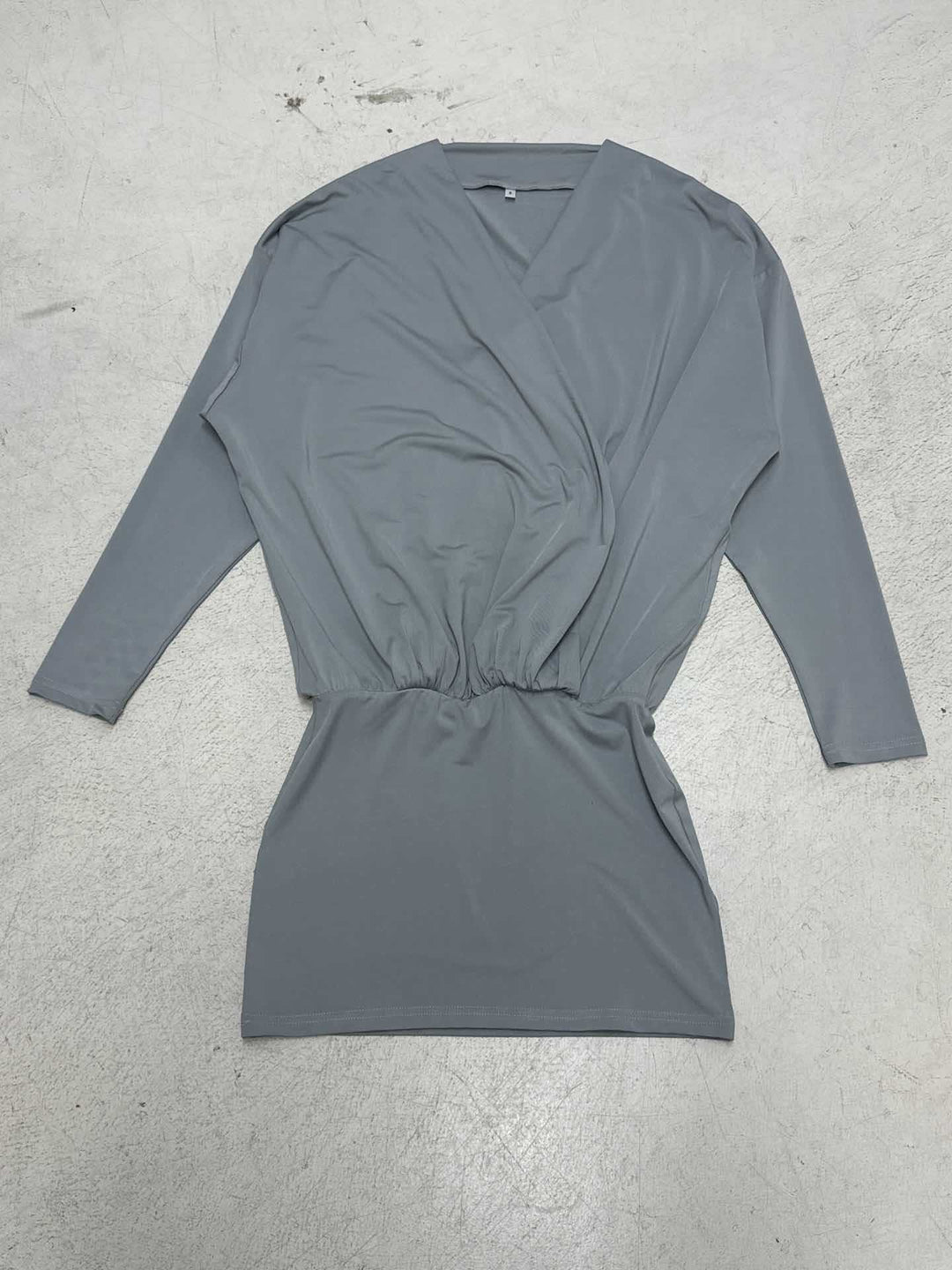 Women's draped wrap top with deep V-neckline, soft jersey drape, and fitted cuff Mune Fashion