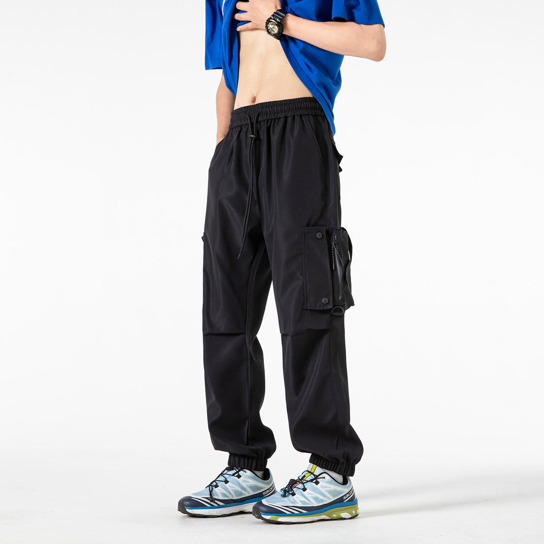 Men's Wide Technical Cargo Jogger with elastic drawstring waistband, multifunctional cargo pockets and adjustable leg openings Drune