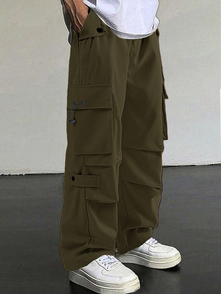 Men's baggy cargo pants with utilitarian flap pockets, drawstring waistband, and reinforced seams Mune Fashion