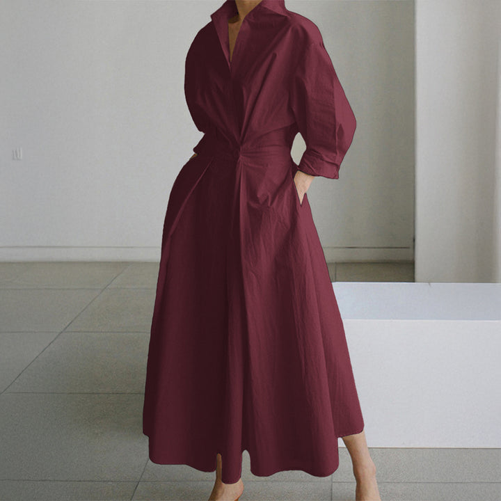 Women's tailored shirt dress with boxy collar, mid-length sleeves, side pockets, and flared pleated skirt Mune Fashion