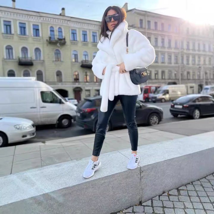 Ladies short coat made of luxurious faux fur with a waist belt and high shawl collar Mune Fashion