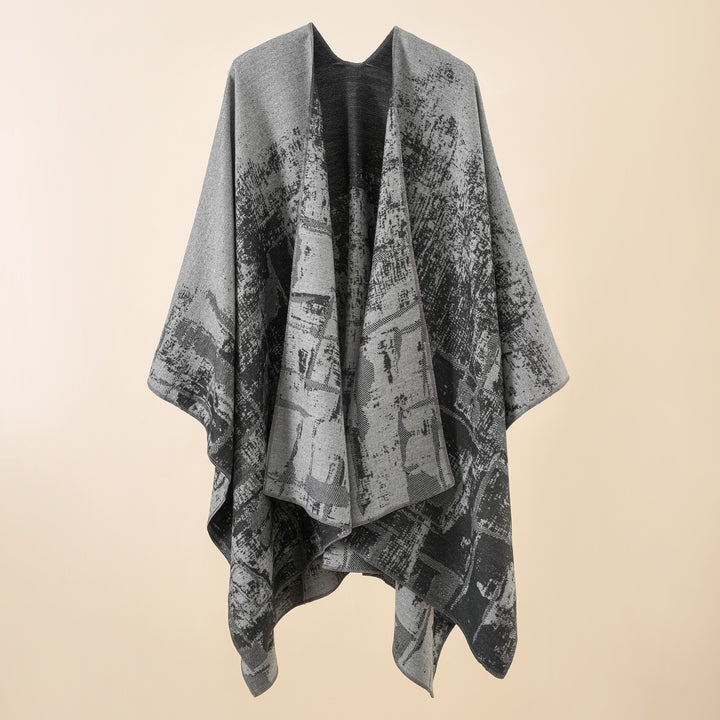 Women's wool blend cape with graphic jacquard, open kimono fall, and soft draping.