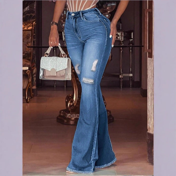 Women high-waisted flared trousers made of stretch denim with flared leg, knee rips, and frayed hem Mune Fashion