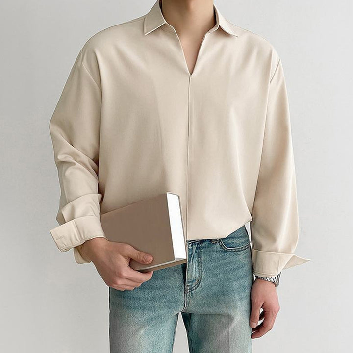 Women's loosely cut tunic blouse with deep V-neck, concealed button placket, and dropped shoulders Mune Fashion