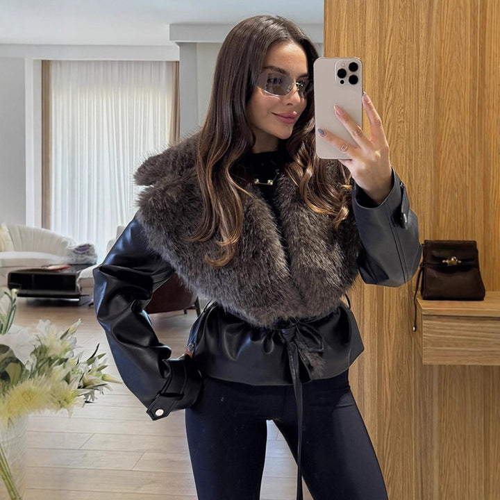 Women's short jacket in biker blouson style made of imitation leather with voluminous faux fur shawl collar and waist belt Mune Fashion