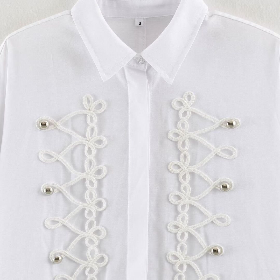 Women's blouse with long sleeves and decorative frog jewelry as well as concealed button placket