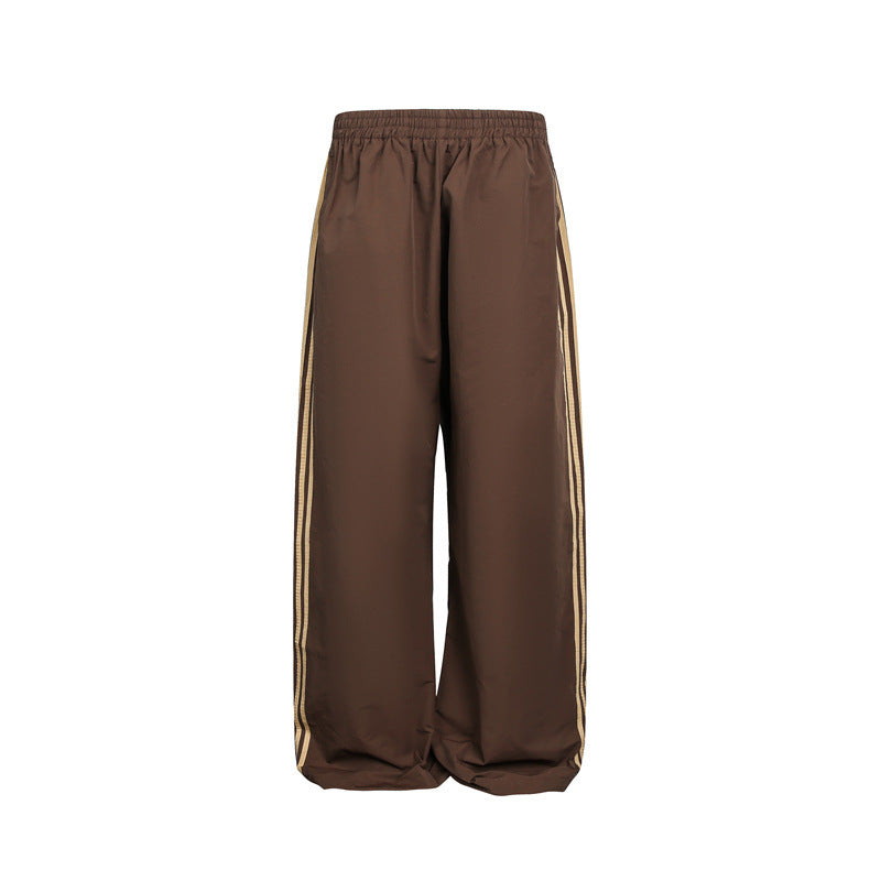 Women's wide satin training pants with elastic waistband and side contrast stripes Mune Fashion
