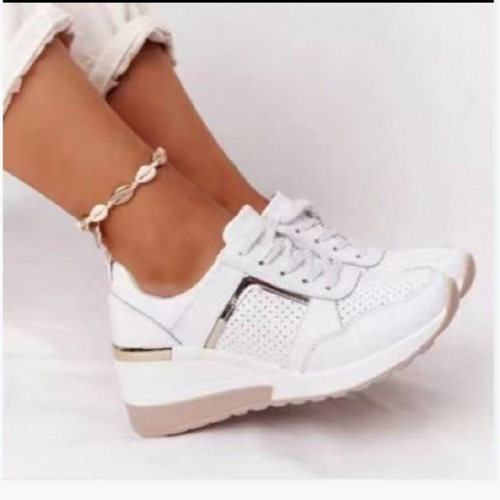 Women's wedge sneakers with perforated upper material, padded comfort collar and reflective metal details Mune Fashion
