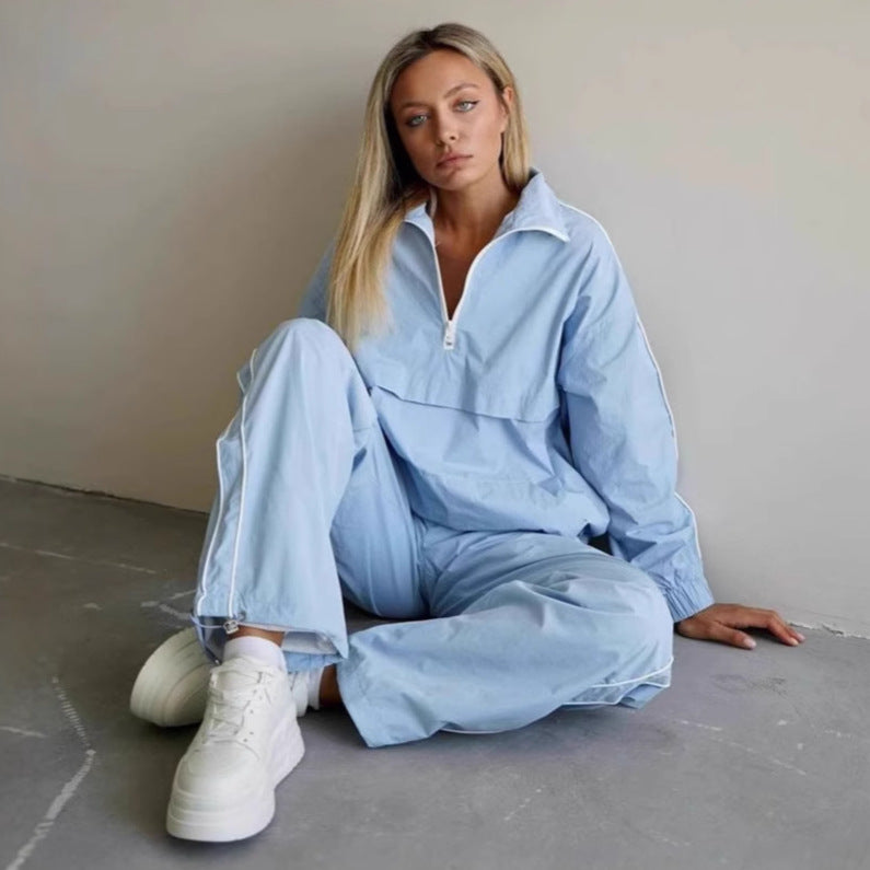 Women's lightweight half-zip windbreaker top with kangaroo pocket, elastic cuffs, and side piping Mune Fashion