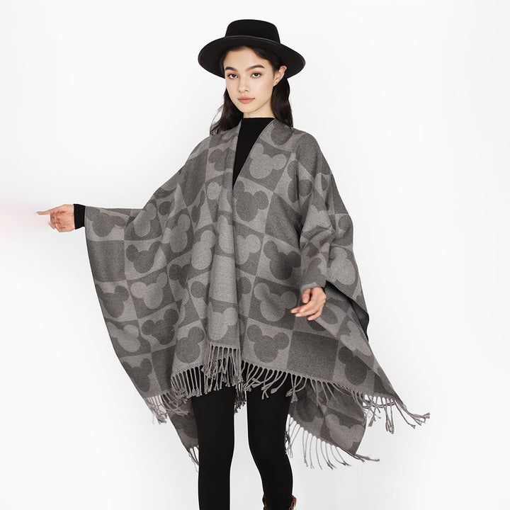 Women's jacquard poncho with figurative head silhouette pattern, fringe and open drape