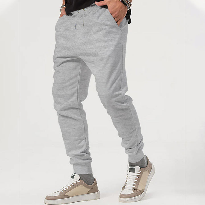 Men's nan tapered jogging pants with elastic drawstring waistband, practical side pockets, and narrow cuff hem Mune Fashion