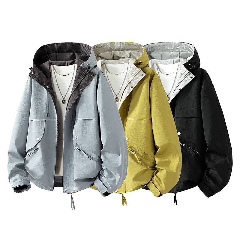 Unisex lightweight windproof transitional jacket with adjustable hood, drawstring, and zippered pockets Mune Fashion