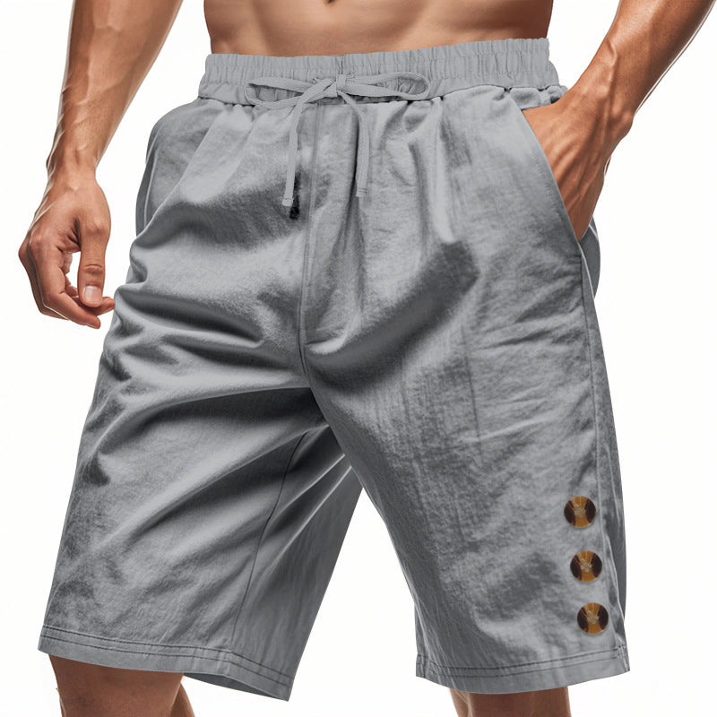 Men's knee-length casual Bermuda shorts with elastic tunnel drawstring waist, side slit pockets, and round decorative appliqués Mune Fashion