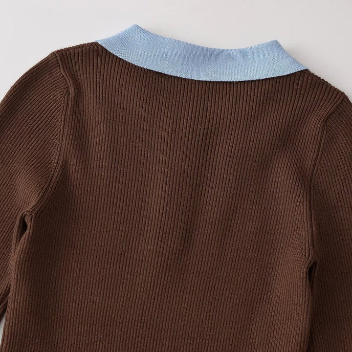 Women's figure-hugging ribbed knit sweater with polo collar, button placket, and color block details Mune Fashion