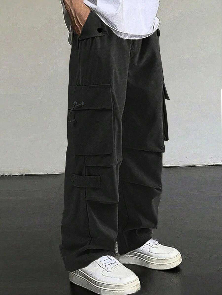 Men's baggy cargo pants with utilitarian flap pockets, drawstring waistband, and reinforced seams Mune Fashion
