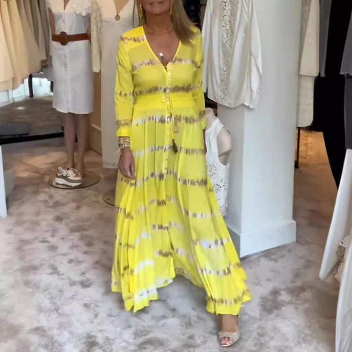 Women's flowing maxi dress with V-neck, full button placket, fitted tassel belt, and pleated skirt Mune Fashion