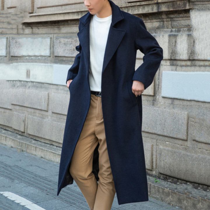 Men's long cut wool coat in minimalist design with generous shawl collar and concealed button placket Mune Fashion