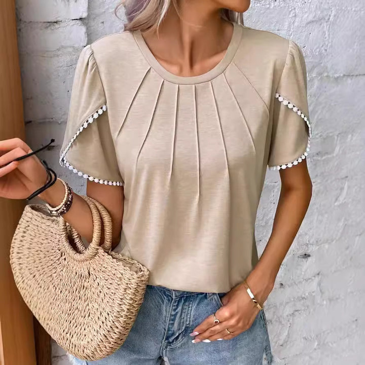 Women's round neck shirt with decorative pleated front, flutter sleeves and pompom trim Mune Fashion