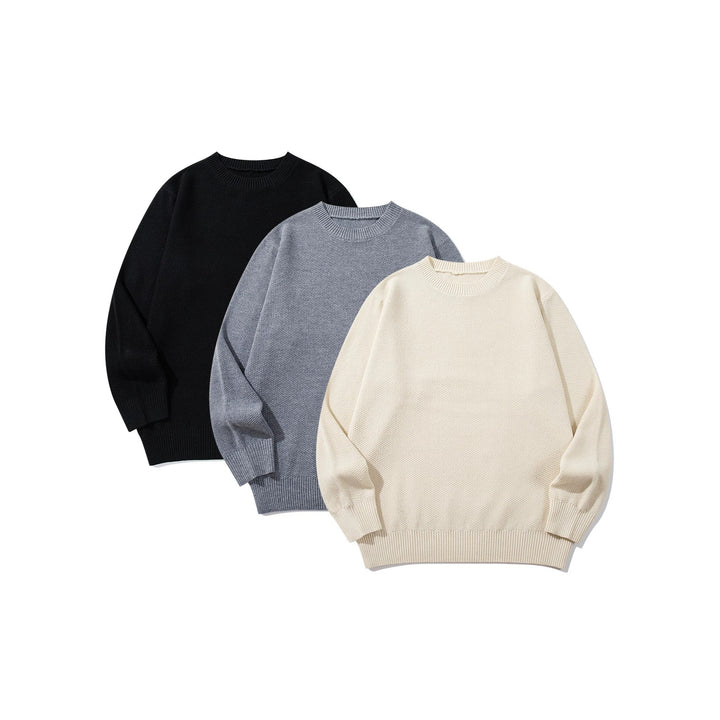 Unisex chunky knit round neck sweater with textured purl stitch and ribbed cuffs