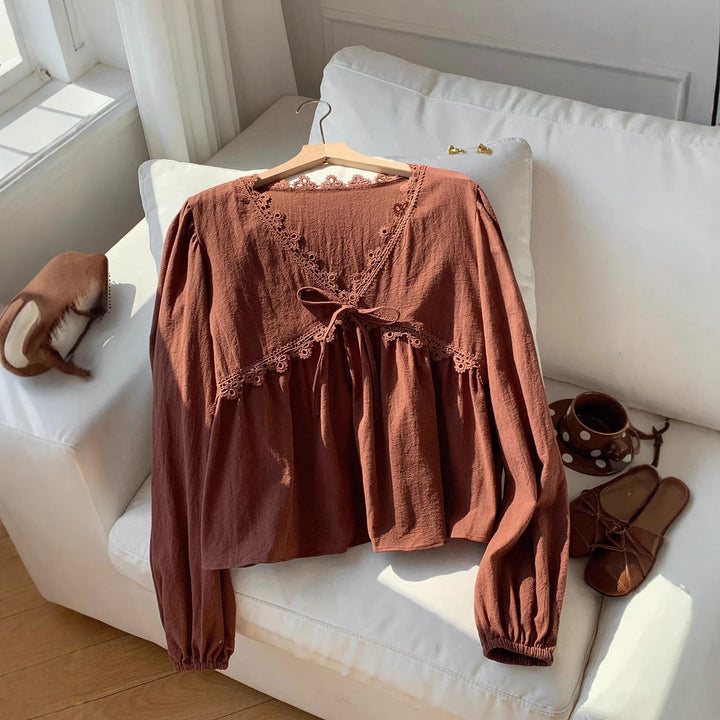 Women’s short blouse with empire cut, V-neck, lace trim, and tie bow Mune Fashion