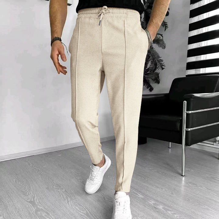 Men's tapered jogging chinos made of structured woven quality with elastic drawstring waistband and decorative crease Mune Fashion