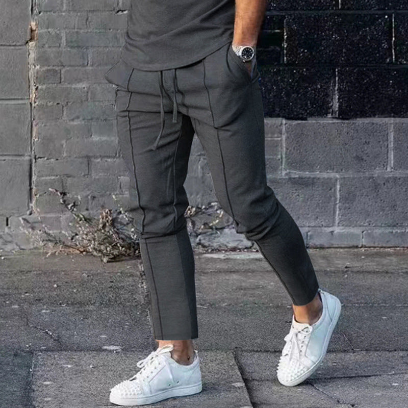 Men's Slim Tapered Jogging Pants with decorative stitching, elastic drawstring, and narrow ankle cuffs Mune Fashion