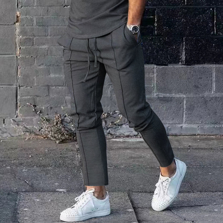 Men's Slim Tapered Jogging Pants with decorative stitching, elastic drawstring, and narrow ankle cuffs Mune Fashion