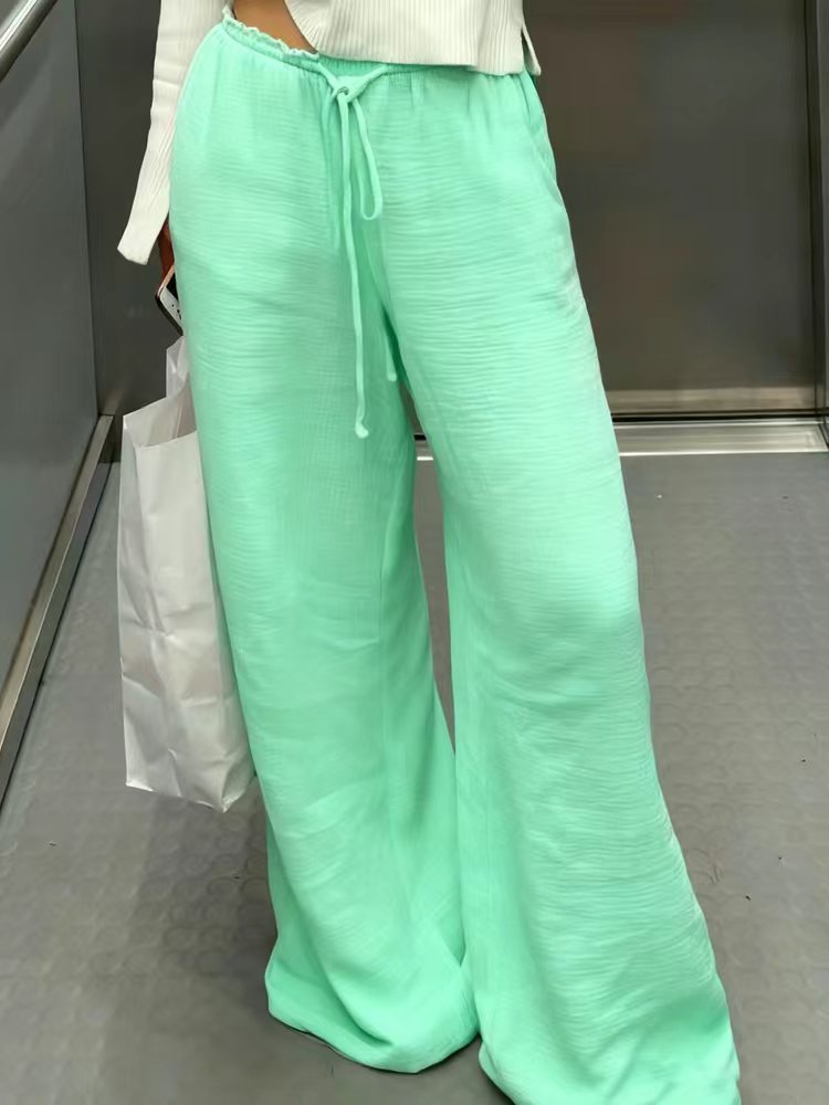Women's linen trousers with a relaxed, ankle-length fit, side pockets and decorative button details Mune Fashion