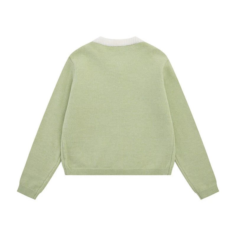 Ladies fine knit cardigan with round neckline, concealed button placket, and decorative brooch Mune Fashion