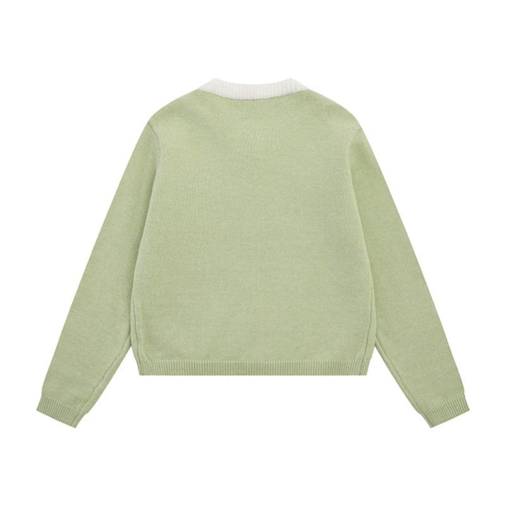 Ladies fine knit cardigan with round neckline, concealed button placket, and decorative brooch Mune Fashion