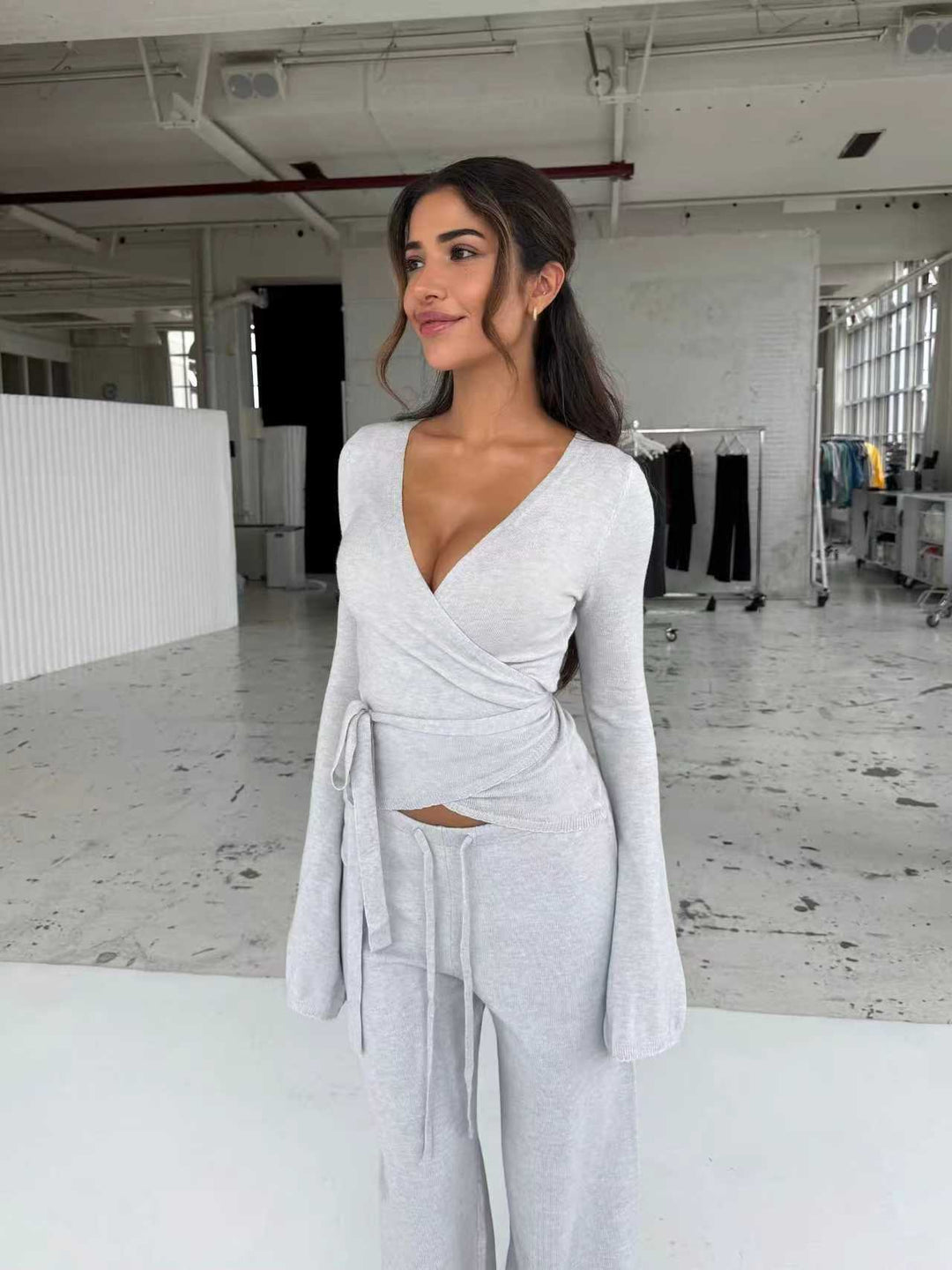Women's knitted wrap top with tie belt and trumpet sleeves, as well as high-waisted wide-cut knitted pants Mune Fashion