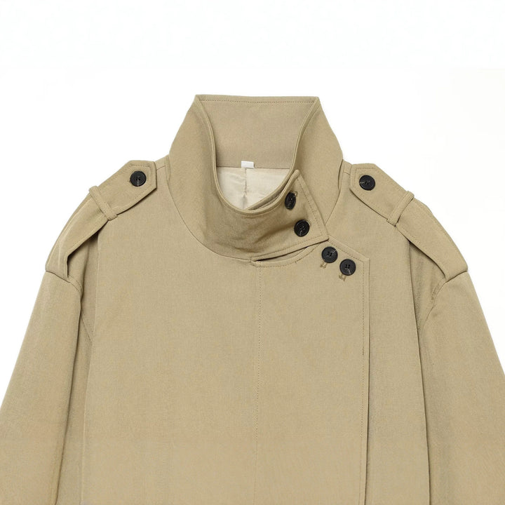 Women's short trench coat with high standing collar, waist belt and shoulder flaps Drune